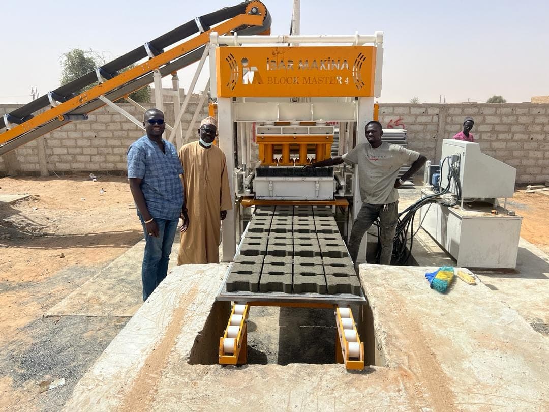 Team at the BLOCKMASTER 4 block making machine after commissioning in Senegal