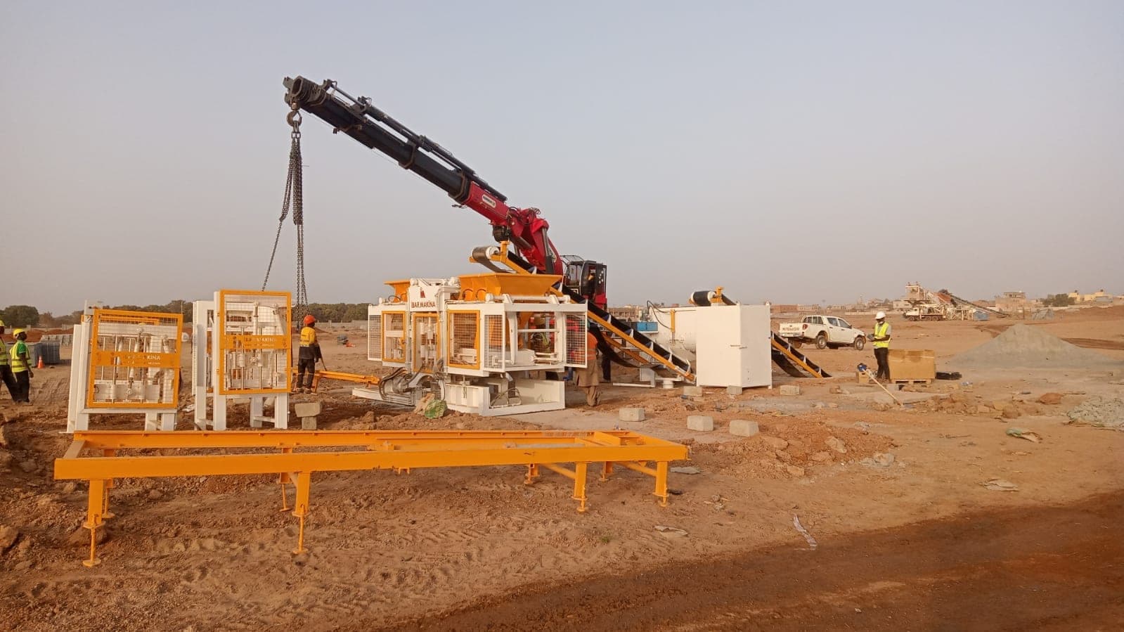 Truck-mounted crane placing the CBM 25 R units during installation in Mali